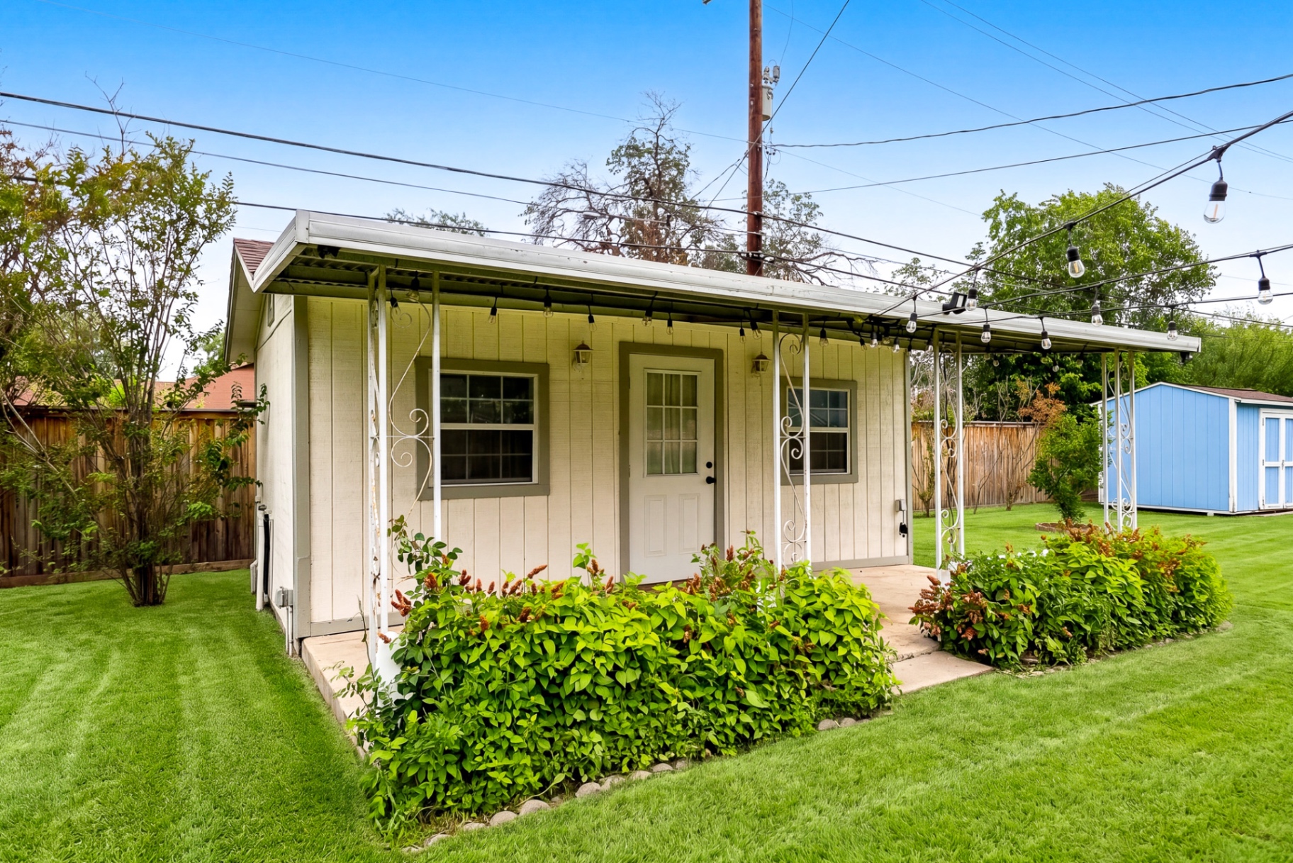 Exterior of the private backyard casita with string lights and landscaped beds at Casa Thorman