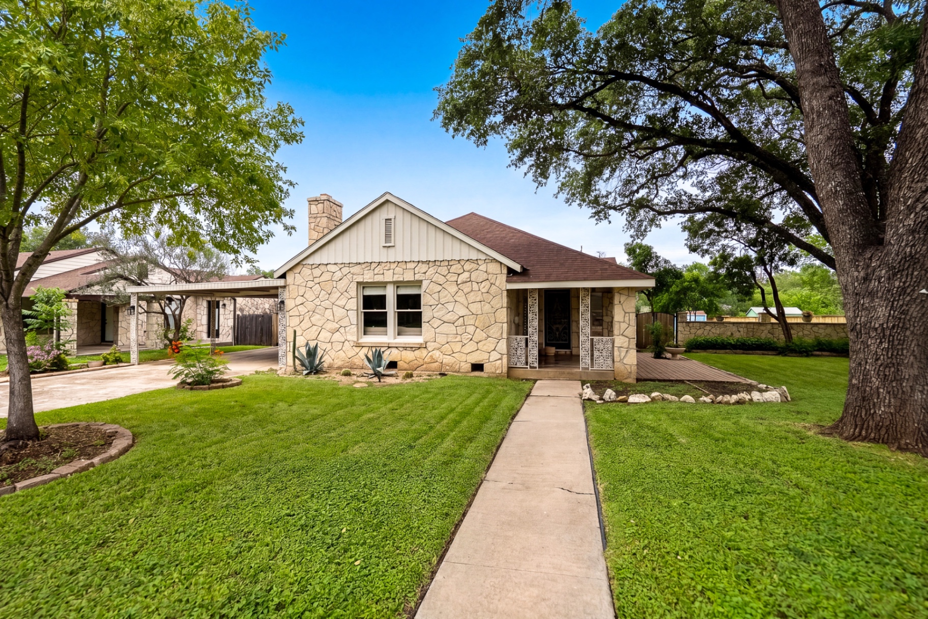 Front exterior of Casa Thorman with original limestone façade and covered carport