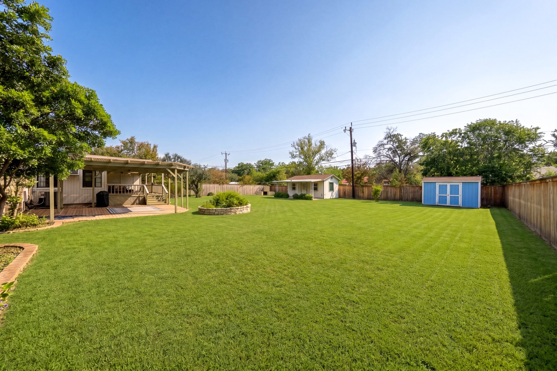 View across the lawn to the private casita at the back of the lot at Casa Thorman